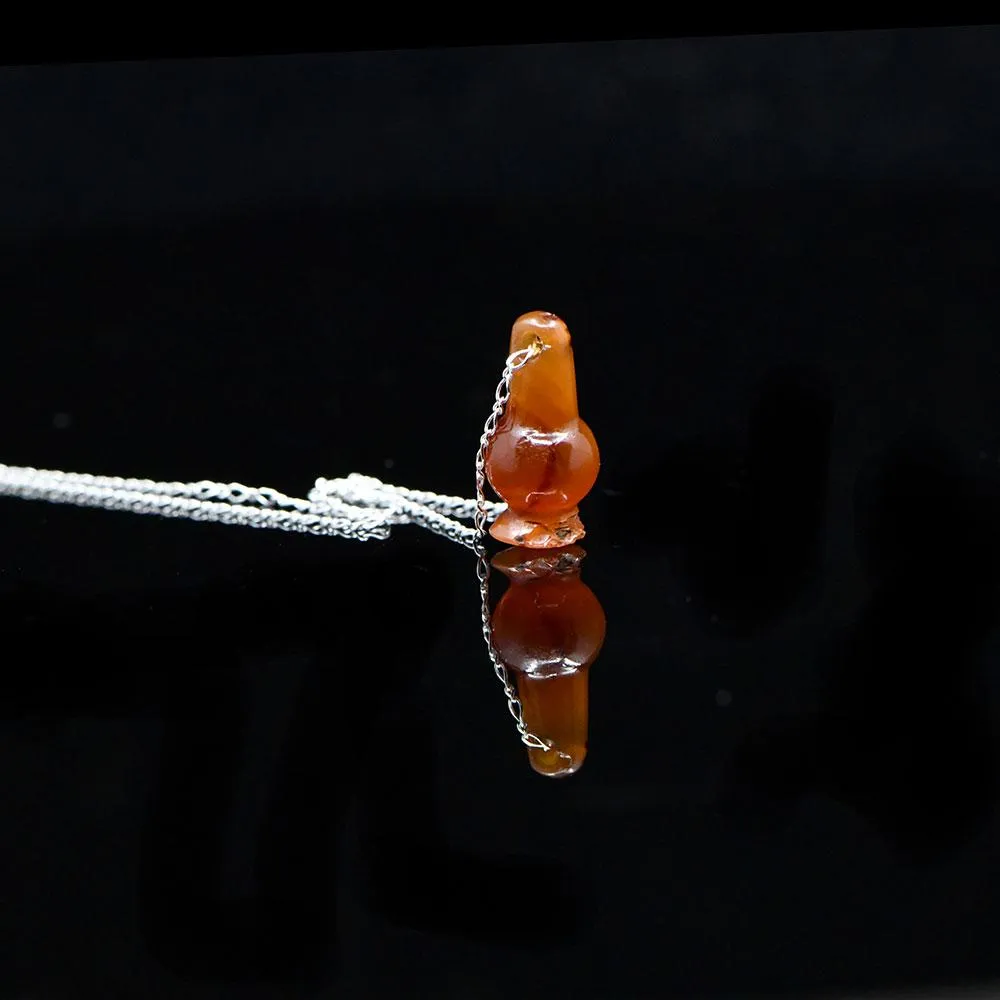 An Egyptian Carnelian Poppy Bead Pendant, New Kingdom, 18th - 19th Dynasty, ca. 1550 - 1295 BCE