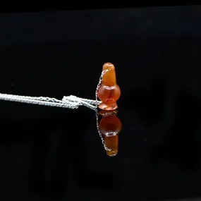 An Egyptian Carnelian Poppy Bead Pendant, New Kingdom, 18th - 19th Dynasty, ca. 1550 - 1295 BCE